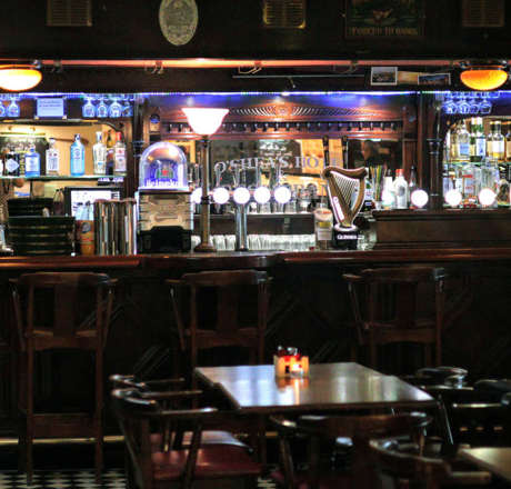 A general shot of the Oshea's Bar, showing various bottles in the background as well as the seating available